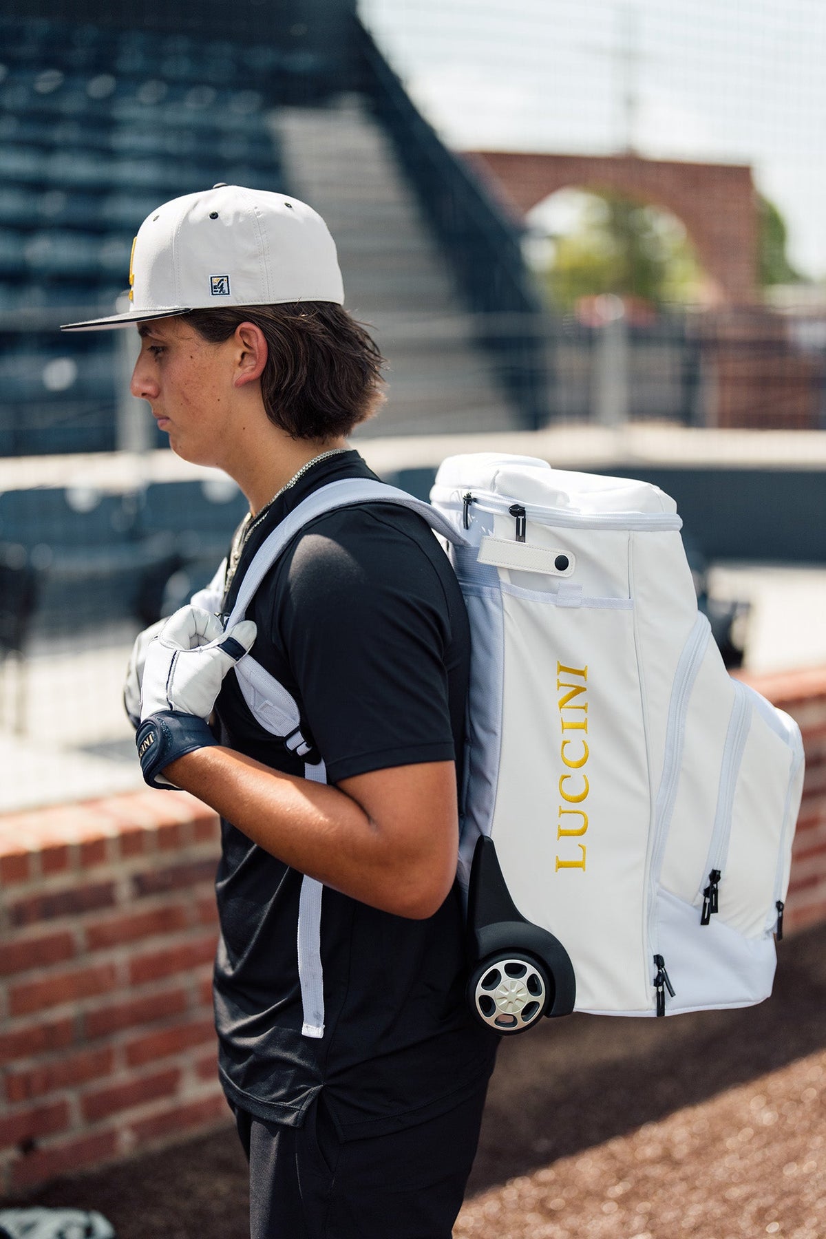 Luccini white wheeled gear bag with durable zippered storage and rolling wheels