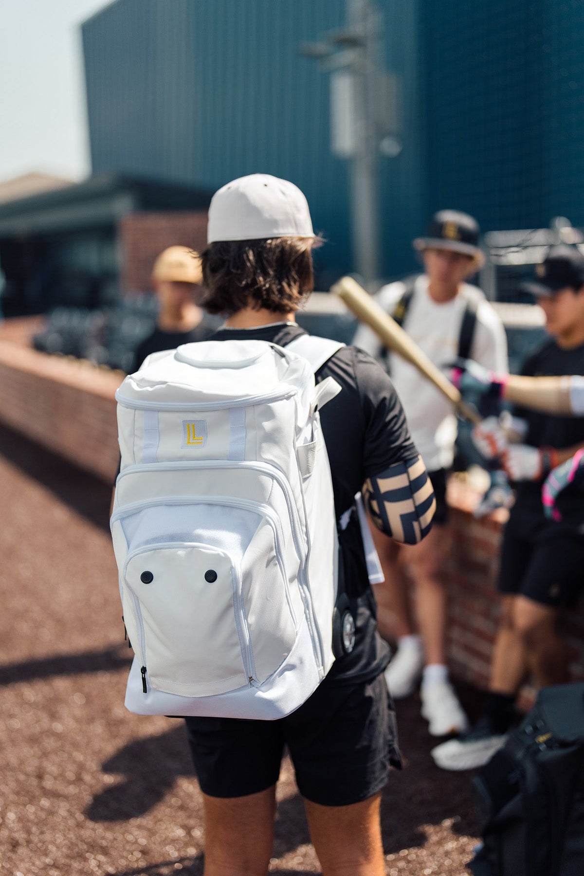 Luccini white wheeled gear bag with durable zippered compartments and retractable handle