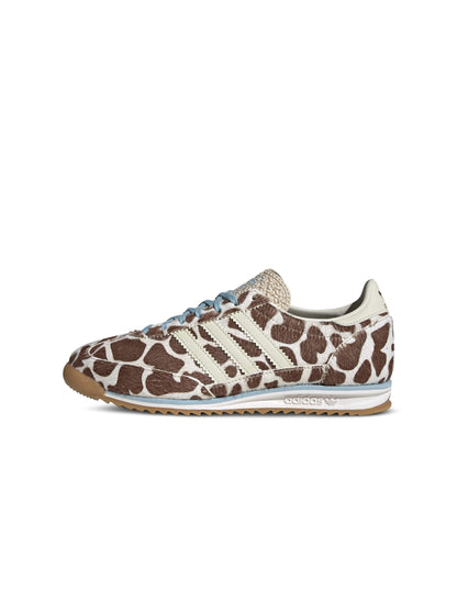 Adidas Women's SL 72 OG cow print sneakers from a left side view, showcasing white footwear with black cow print pattern.