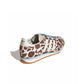 Adidas Womens SL 72 OG cow print sneakers shown from back, lateral, and top view, featuring white footwear with black cow print accents.