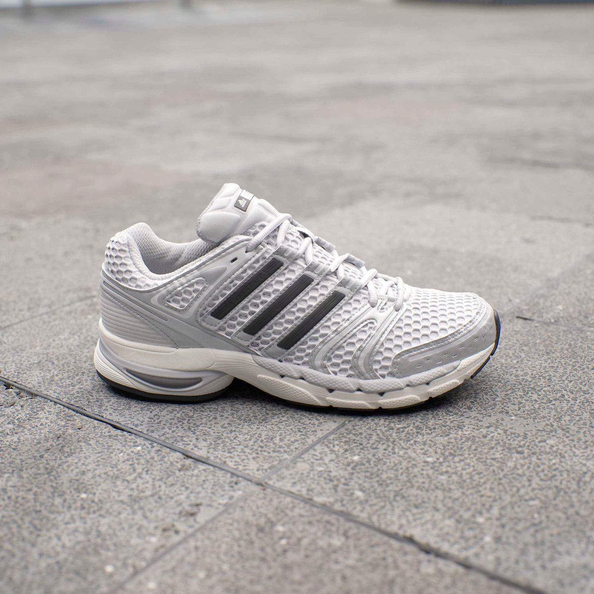 Silver Adidas Mens Adistar Control 5 running shoes with sleek design, lightweight mesh upper, and supportive sole for active wear.