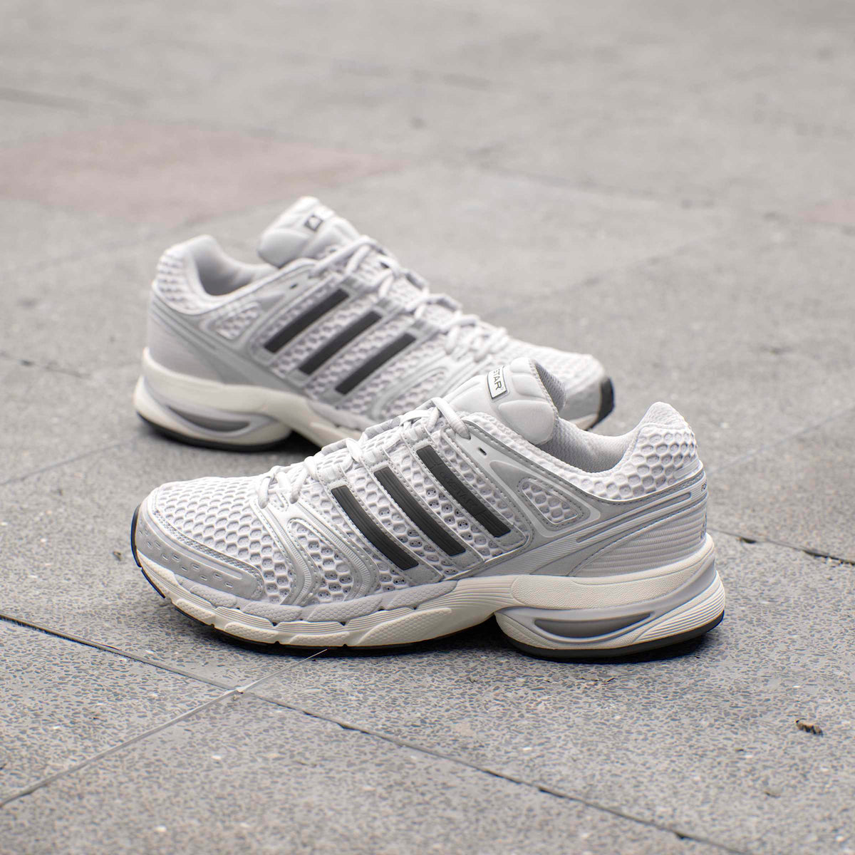 Silver Adidas Mens Adistar Control 5 running shoes with breathable mesh and supportive sole, designed for comfort and performance.