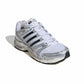 Silver Adidas men's Adistar Control 5 athletic footwear shown from front, side, and top view, featuring a sleek design and supportive construction.