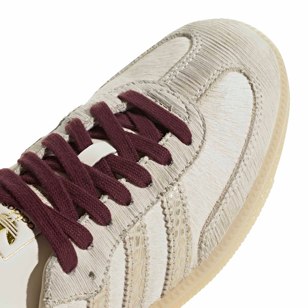 Adidas Women's Samba OG cream and maroon sneakers, detailed view showing white leather upper and maroon accents.