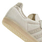 Adidas women's Samba OG cream and maroon sneakers, detailed view of white leather and rubber sole, stylish women's footwear.