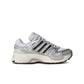 Adidas Big Kids Adistar Control 5 gradeschool white and silver athletic shoes, side view showing design details.