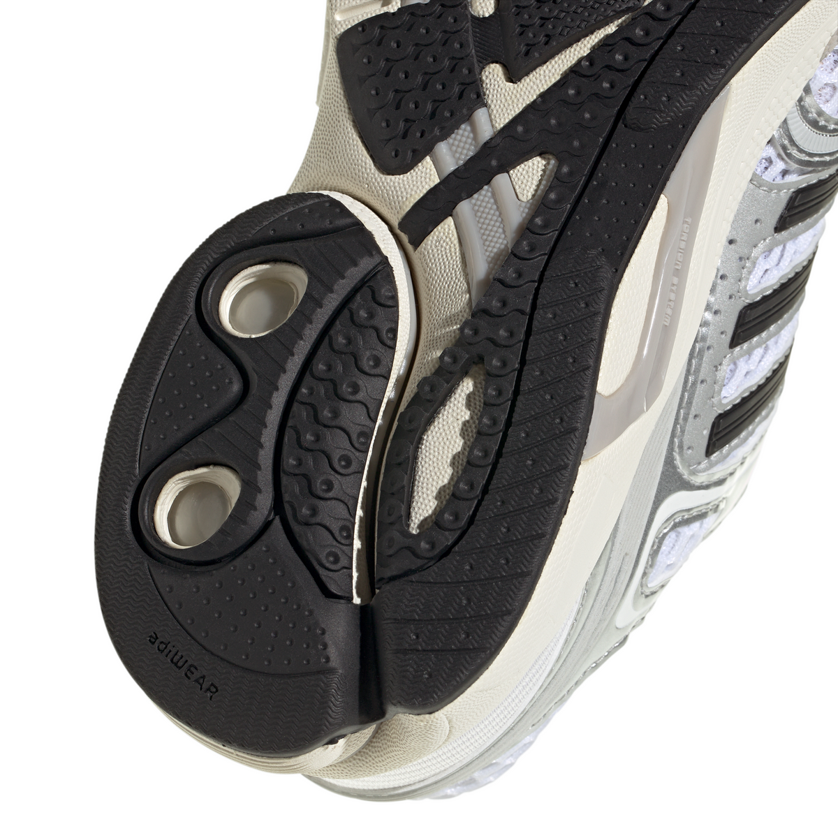 White and silver Adidas Big Kids Adistar Control 5 gradeschool footwear with detailed stitching and logo on the side.