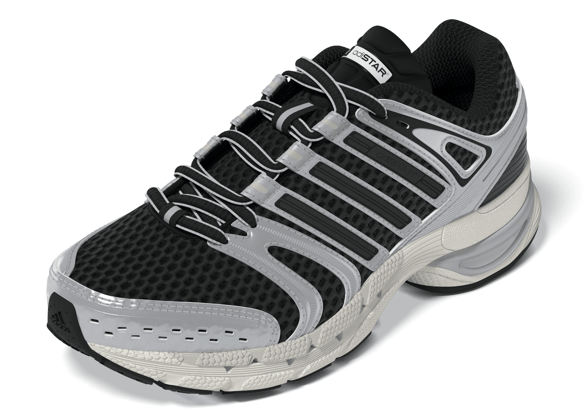 Black and silver Adidas Big Kids Adistar Control 5 gradeschool sneakers, side view showing stylish athletic design.