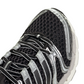 Black and silver Adidas Big Kids Adistar Control 5 grade school sneakers with detailed view of design and materials.