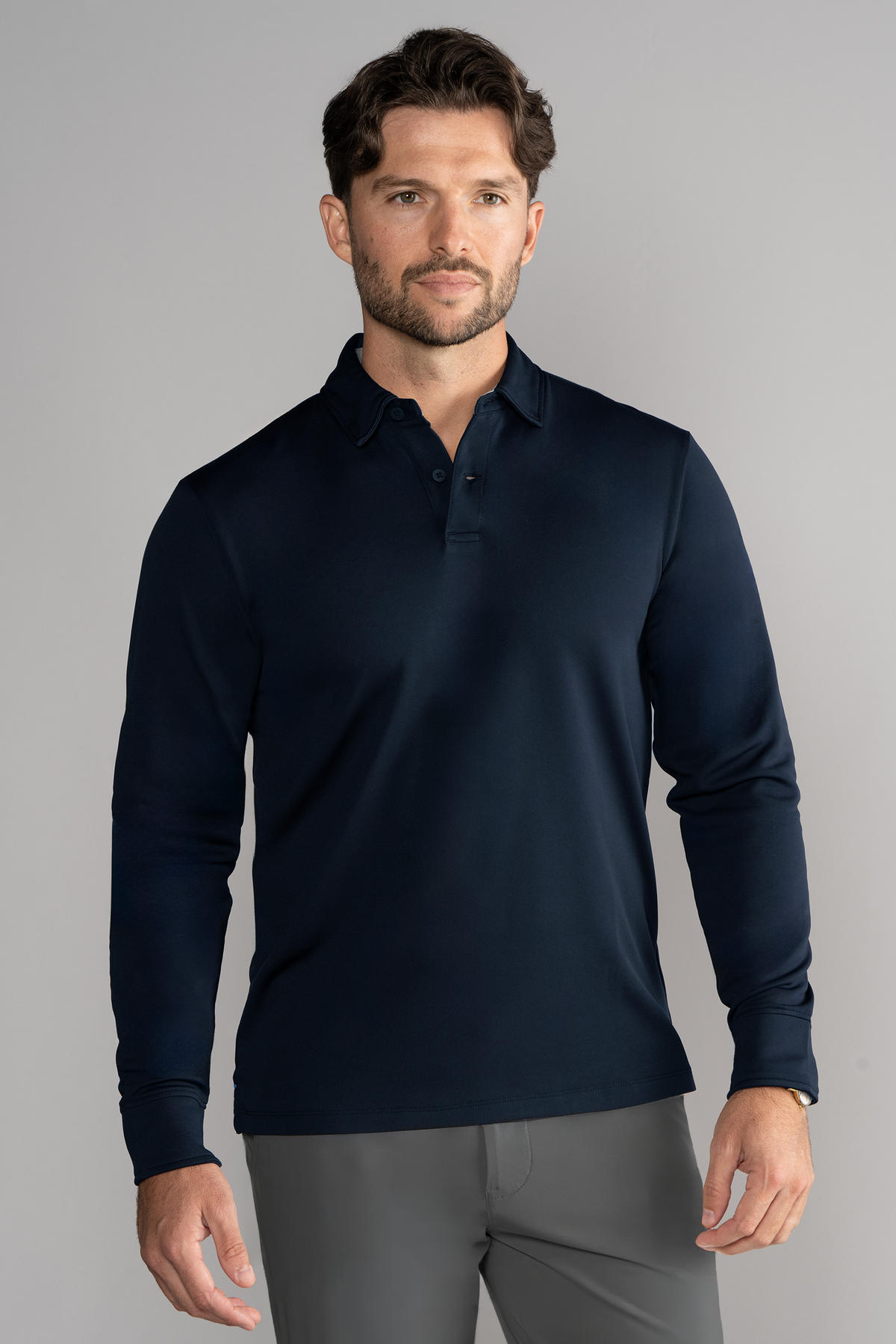 Navy solid long sleeve polo shirt by Twillory, front view showing classic collar and button placket, tailored fit.
