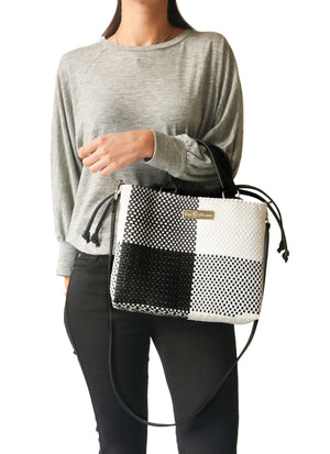 Medium woven crossbody bag with drawstring closure by Tin Marin Brand, featuring stylish craftsmanship and versatile design.