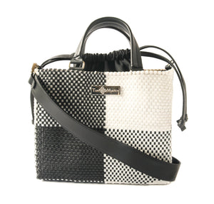 Tin Marin Lucy Medium Woven Crossbody Bag with drawstring closure, featuring a woven fabric design and adjustable strap.