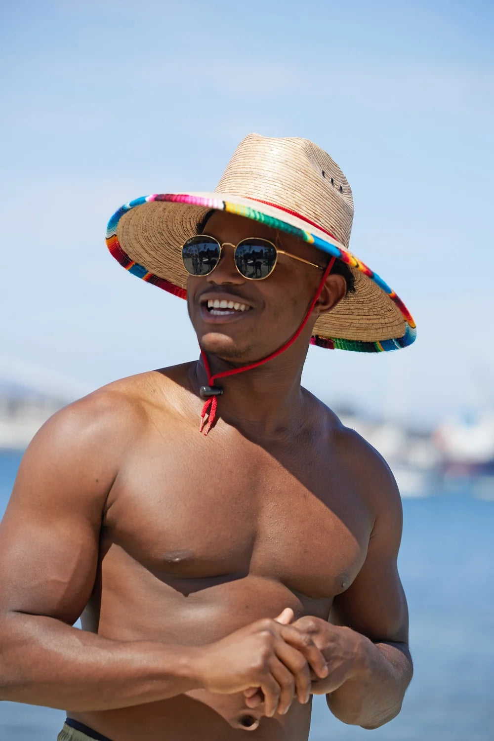 Peter Grimm Luz straw lifeguard hat with wide brim and chin cord, shown in natural tan color