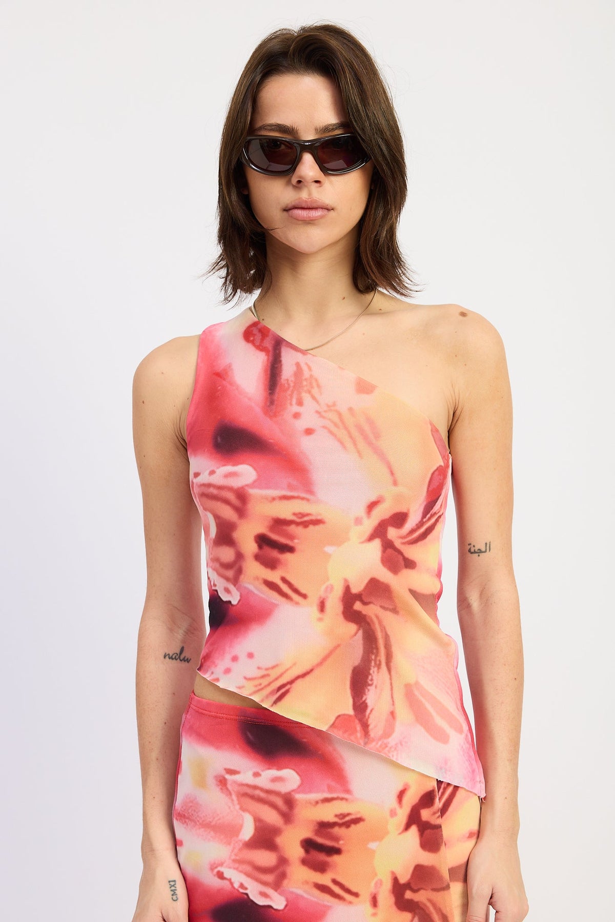 Emory Park Lilah Top in rose pink floral print, lightweight fabric with a fitted design, displayed on a hanger.