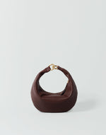 HYER GOODS Micro Ring Hobo Bag in Bordeaux with rounded shape and adjustable strap, showcasing textured leather and minimalist design.