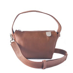 Tan Maina shoulder leather bag by Tin Marin Brand with adjustable strap and sleek design, shown from a front angle.