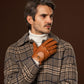 Brown Marcello Italian peccary driving gloves with detailed stitching and leather lining, designed for luxury and comfort.