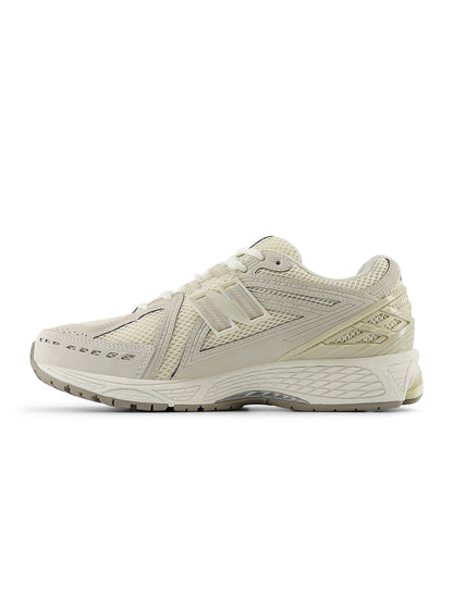 Beige New Balance 1906 men's sneakers with layered mesh and metallic accents