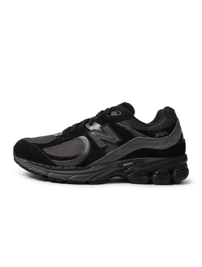 Black New Balance 2002R men's footwear shoes with stylish design, shown from a side angle.