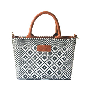 Small woven panda crossbody bag in camel color by Tin Marin Brand, featuring a cute panda face and adjustable strap.