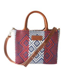 Small woven crossbody bag in camel color by Tin Marin Brand, featuring a compact design with a woven texture.