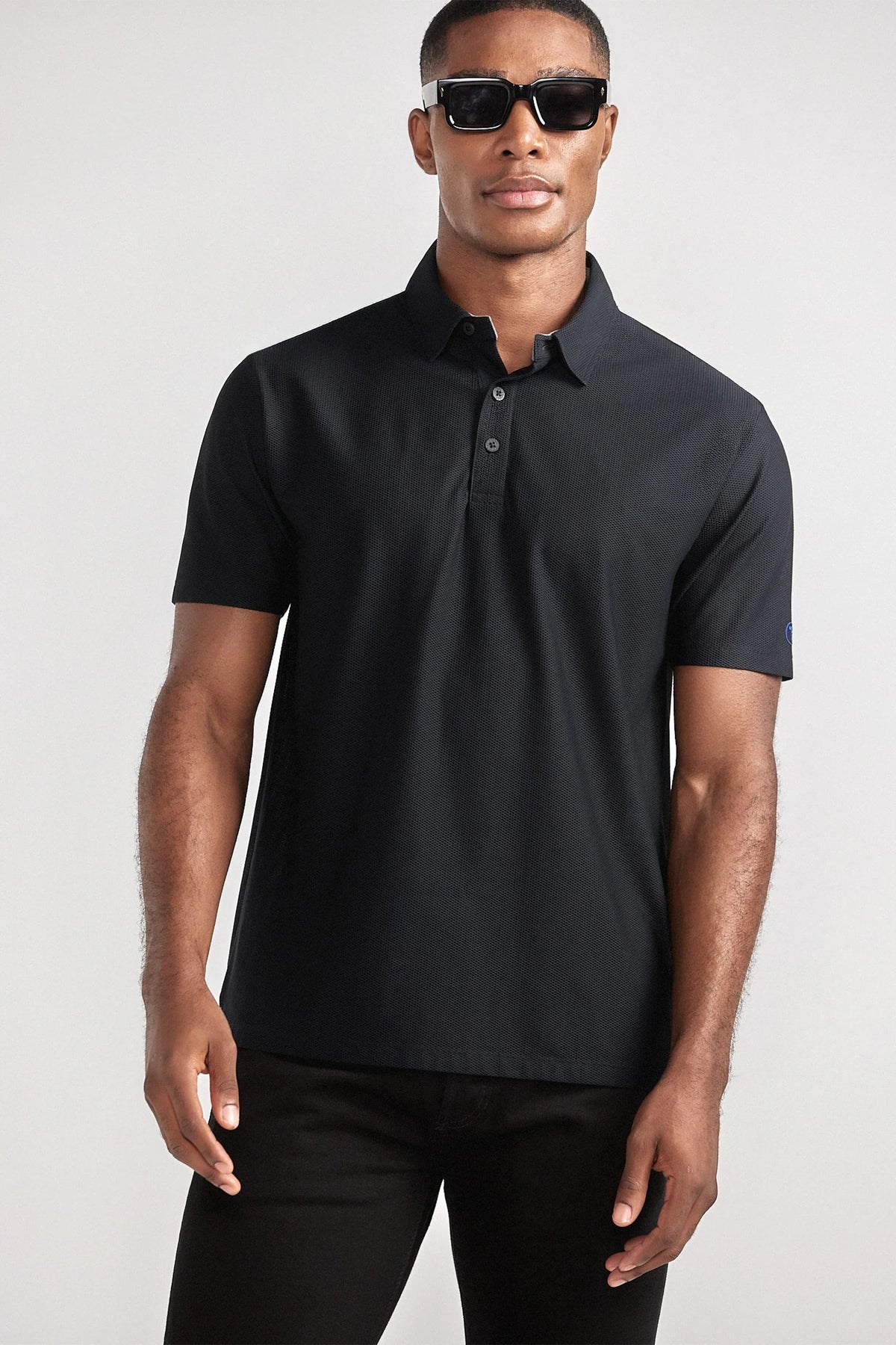 Black AIR 3 Button Polo from Twillory, casual men's shirt with a classic collar and three-button placket, front view.