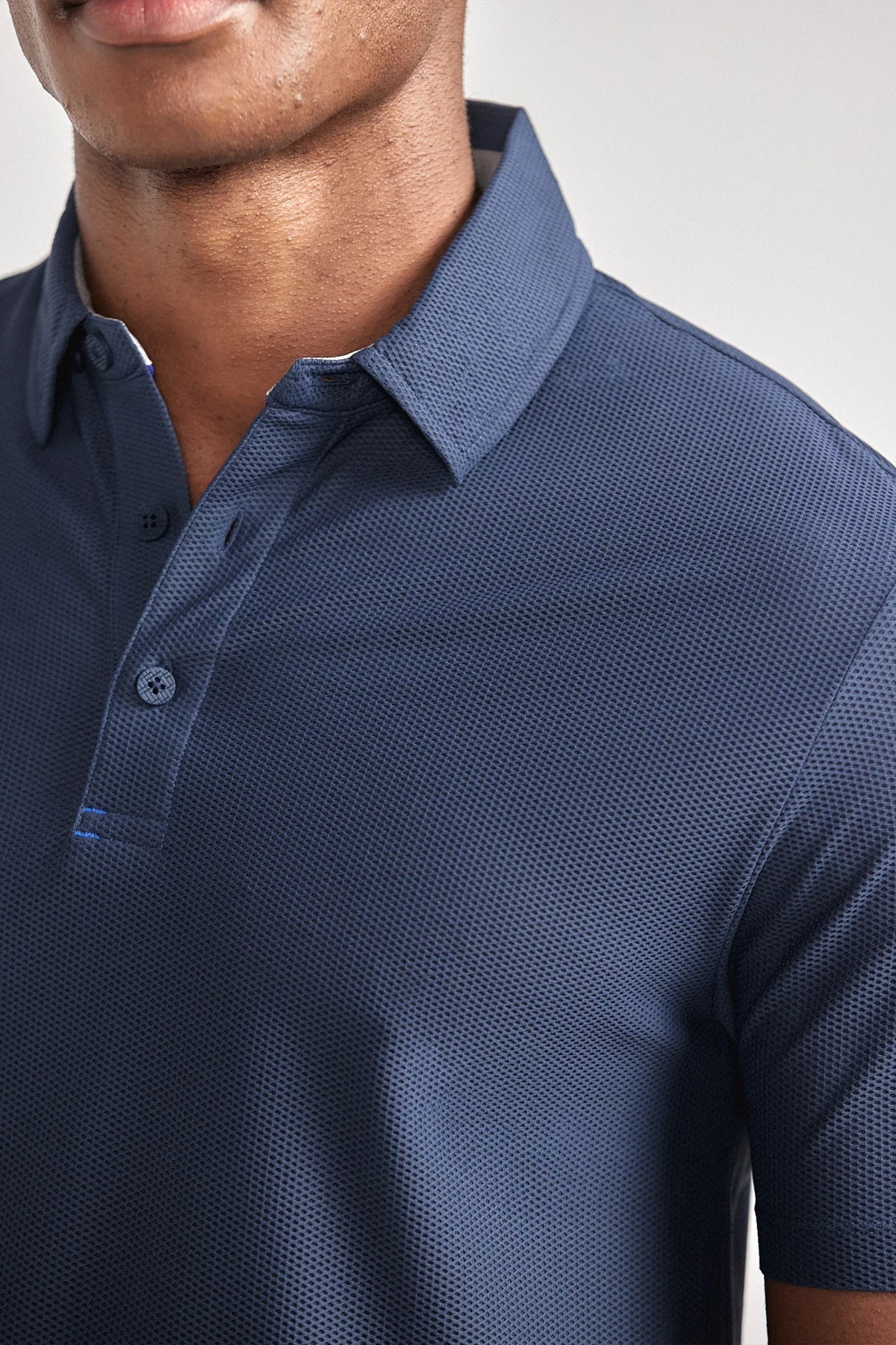 Navy AIR 3 Button Polo Solid casual shirt by Twillory, featuring a classic collar and clean design, displayed on a mannequin.