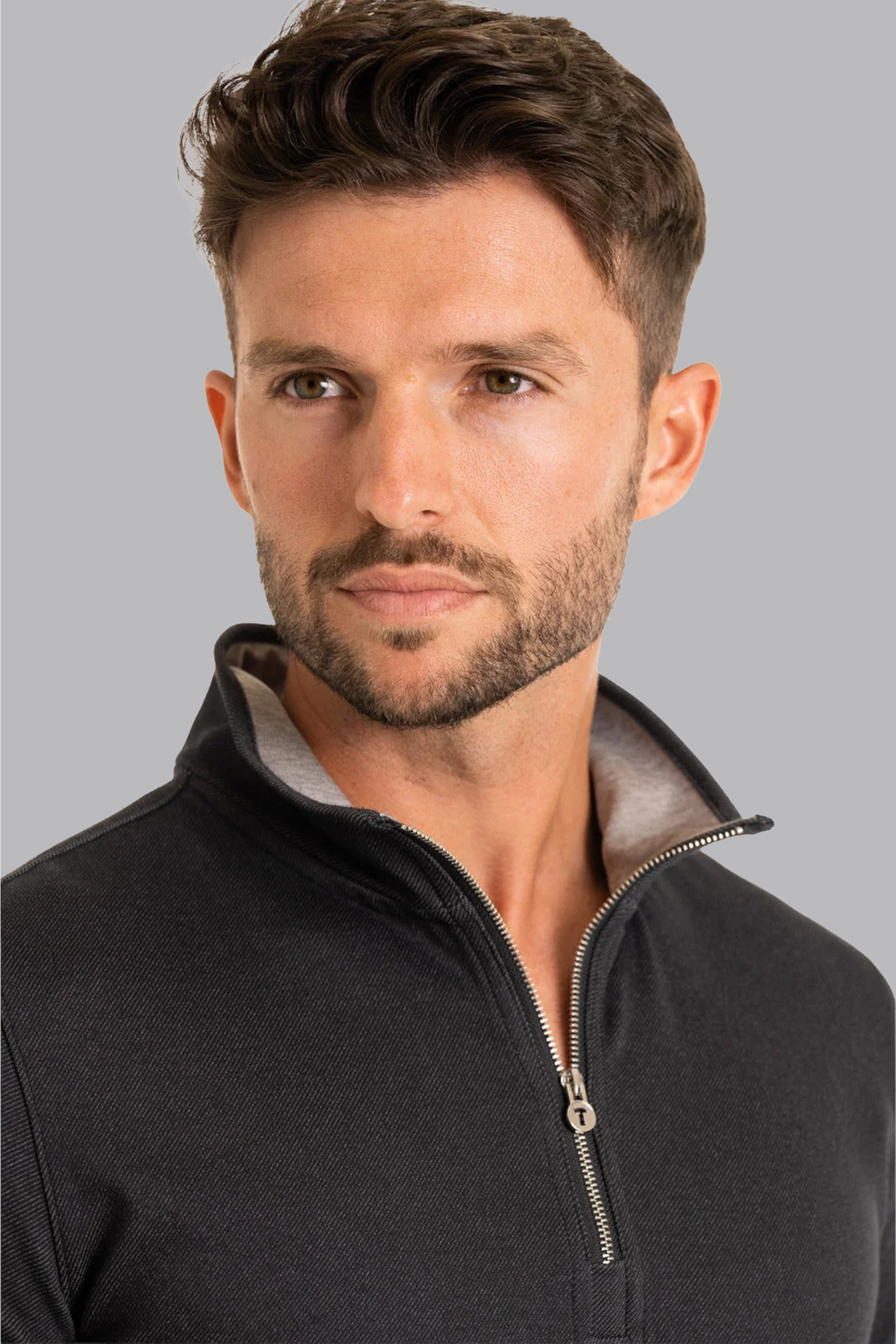Close-up of Twillory men's charcoal performance quarter zip shirt showing fabric texture and zipper details.