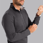 Twillory charcoal performance quarter zip shirt with ribbed cuffs, made from breathable fabric, displayed on a hanger.