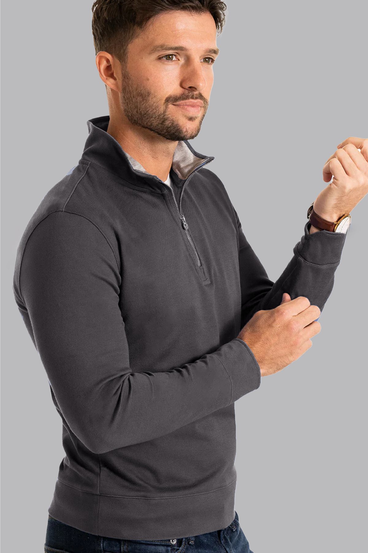 Twillory charcoal performance quarter zip shirt with ribbed cuffs, made from breathable fabric, displayed on a hanger.