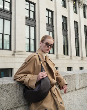 HYER GOODS Ring Bag hobo bag in chocolate suede, showing a stylish, slouchy design with a rounded ring handle and soft texture.