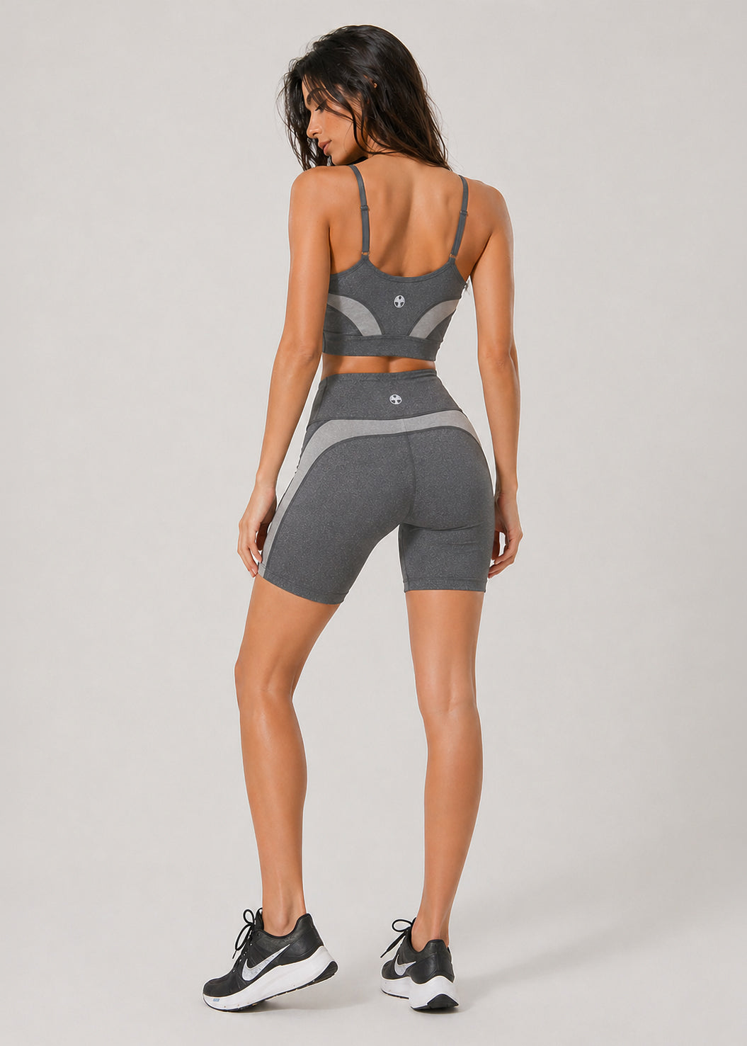 Trophy Yoga Curve Panel sports bra in gray, featuring a supportive racerback design and curved panel detailing
