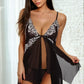 Black lace inset jagged hem babydoll lingerie with sheer fabric and adjustable straps, featuring delicate lace detailing.