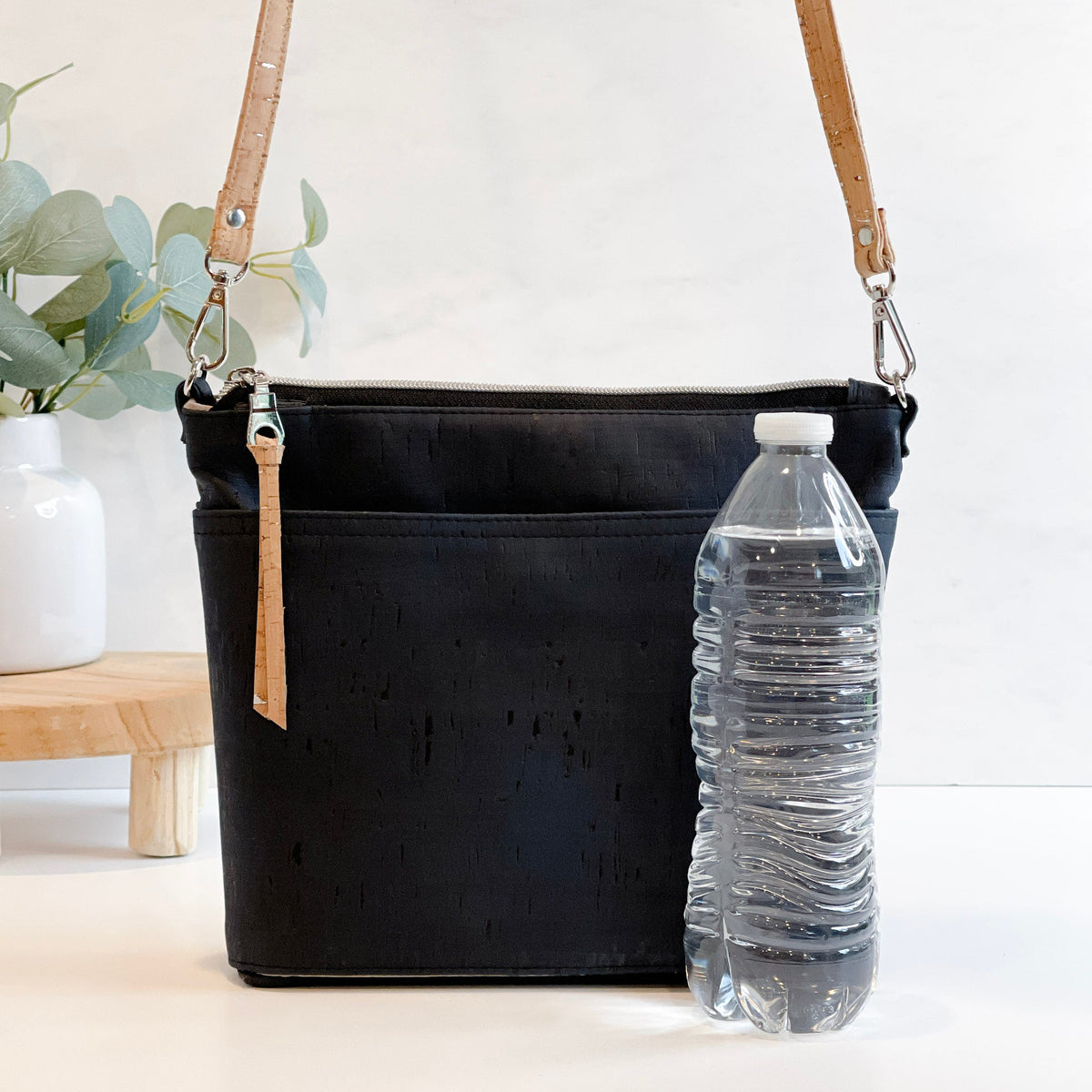 Carry Courage VISIONARY cross body bag in coal black, shown from the side with adjustable strap and zip closure