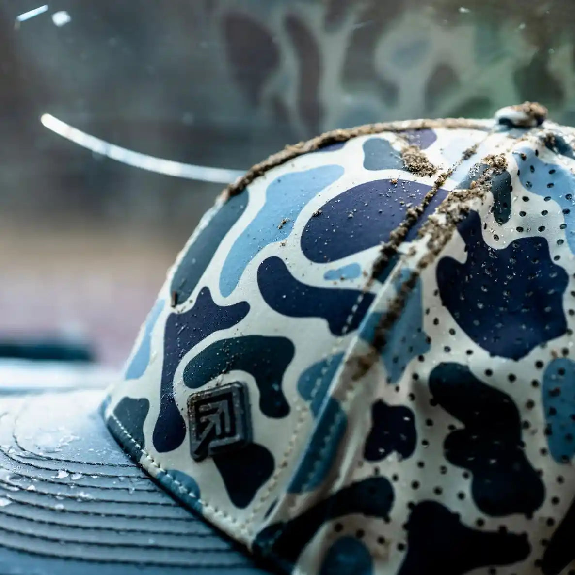 Terreno Hats Ridge Wetland Camo cap with detailed camouflage pattern and adjustable strap, designed for outdoor wear.