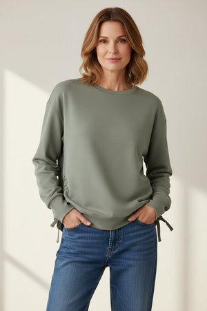Soft sage-colored oversized crew top by KADOU BOUTIQUE, featuring a relaxed fit and comfortable neckline.