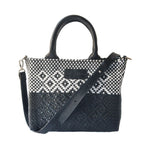 Black small woven crossbody bag by Tin Marin Brand, featuring textured fabric and a compact design for everyday use.