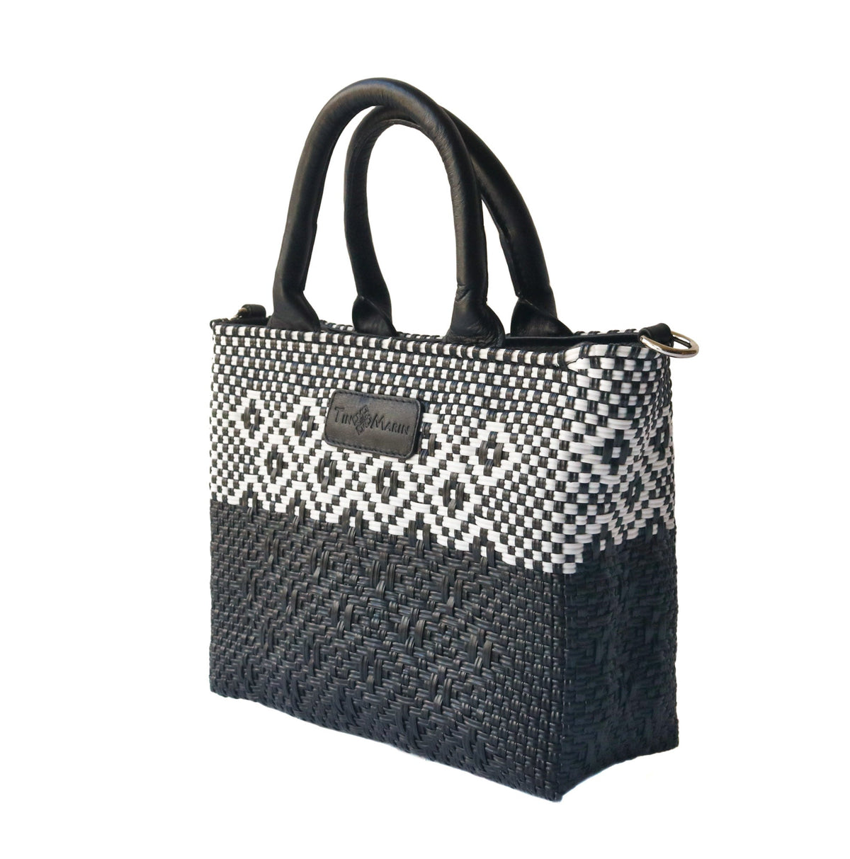 Black small woven crossbody bag by Tin Marin Brand with adjustable strap and textured woven design.