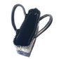 Black small woven crossbody bag by Tin Marin Brand, featuring a compact design with woven texture and adjustable strap.