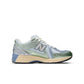 Womens New Balance 1906 sneakers in metallic green with white soles, showcasing stylish athletic footwear for women.