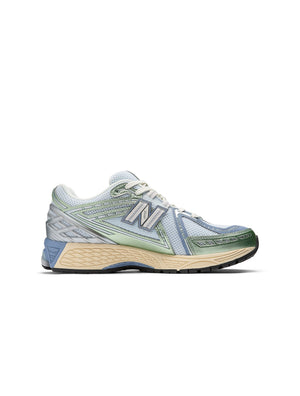 Womens New Balance 1906 sneakers in metallic green with white soles, showcasing stylish athletic footwear for women.