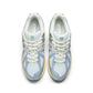 New Balance women's 1906 sneakers in metallic green, showcasing stylish athletic footwear with a shiny finish.