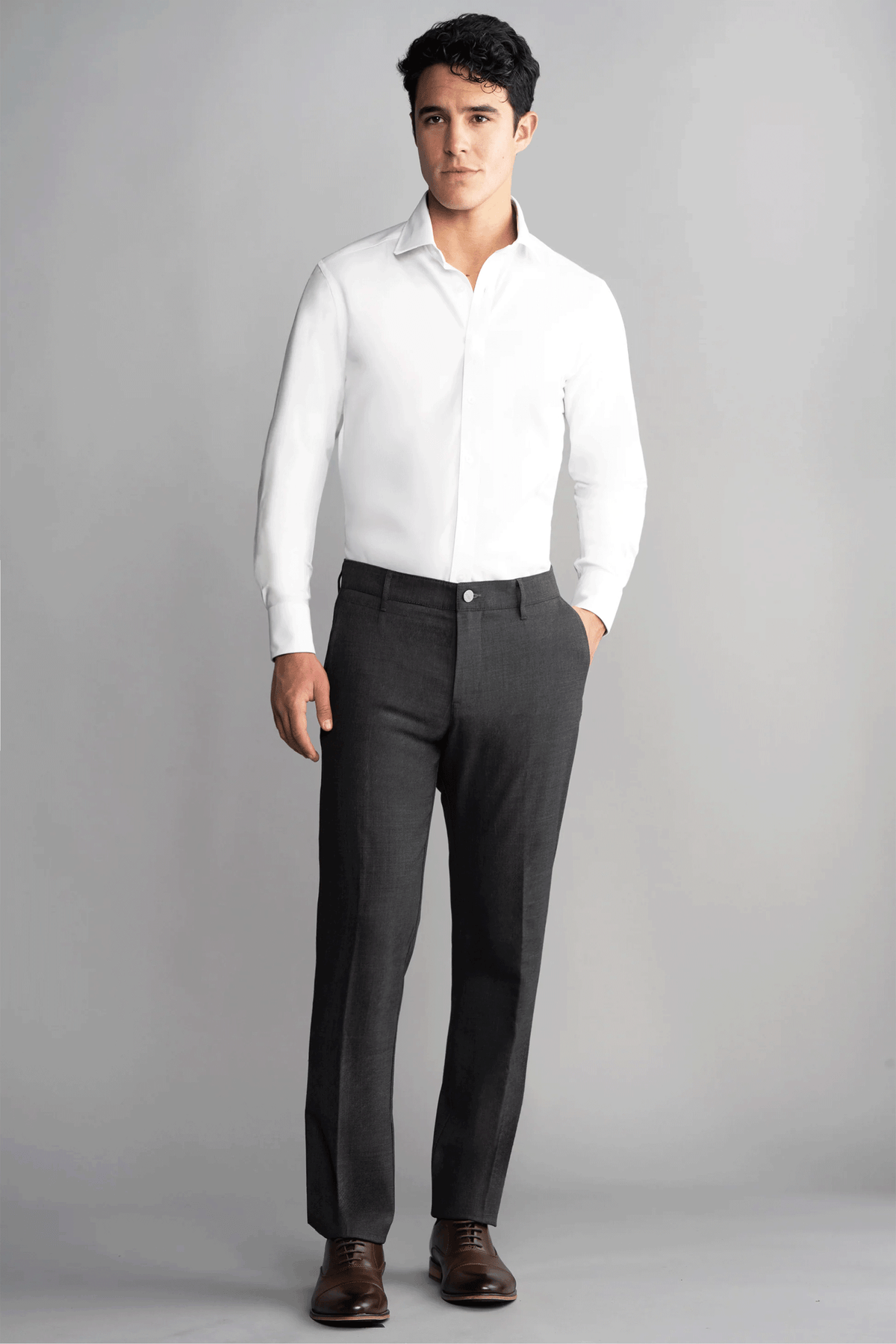 Full-body image of a man wearing a grey Heather Twillory hybrid wool blazer paired with matching wool pants.