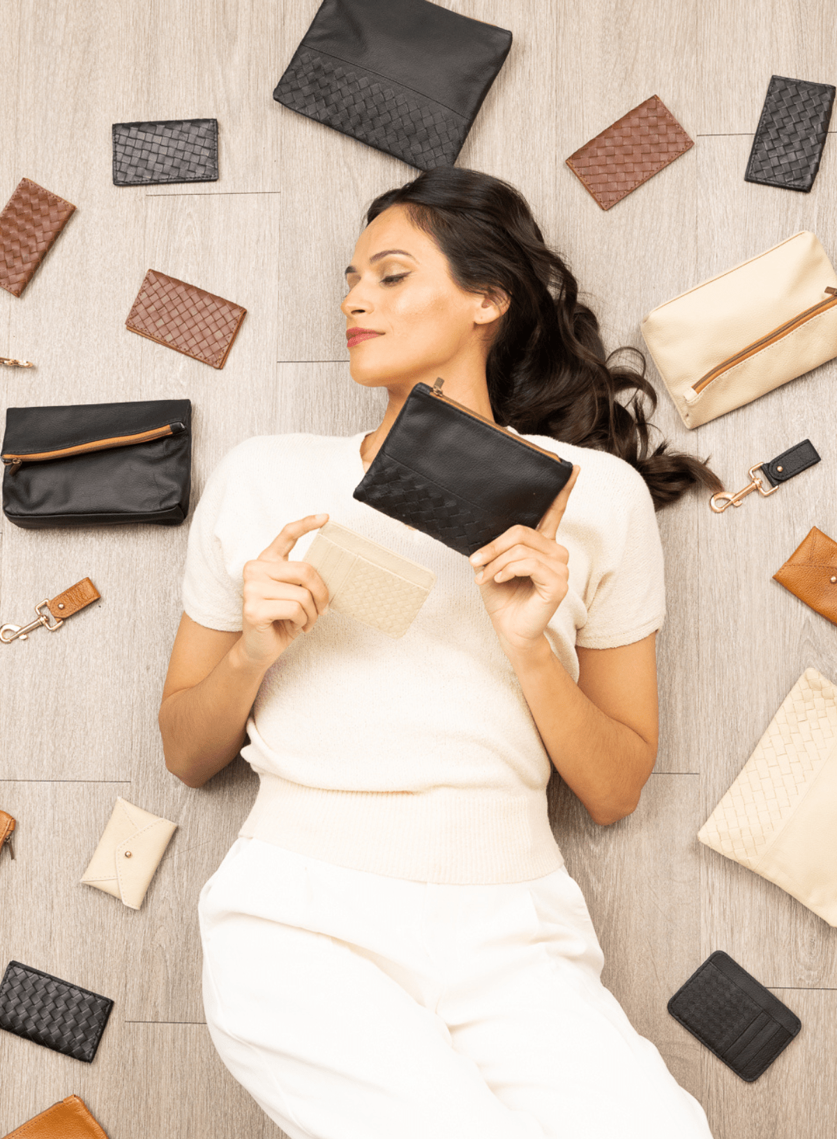 Deux Mains Slim ID Case shown with spring accessories collection bundles on a model laying down