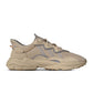 Brown Adidas Men's Ozweego sneakers with mesh and leather details, displayed on white background.