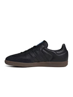Black Adidas Men's Samba OG sneakers, side view.