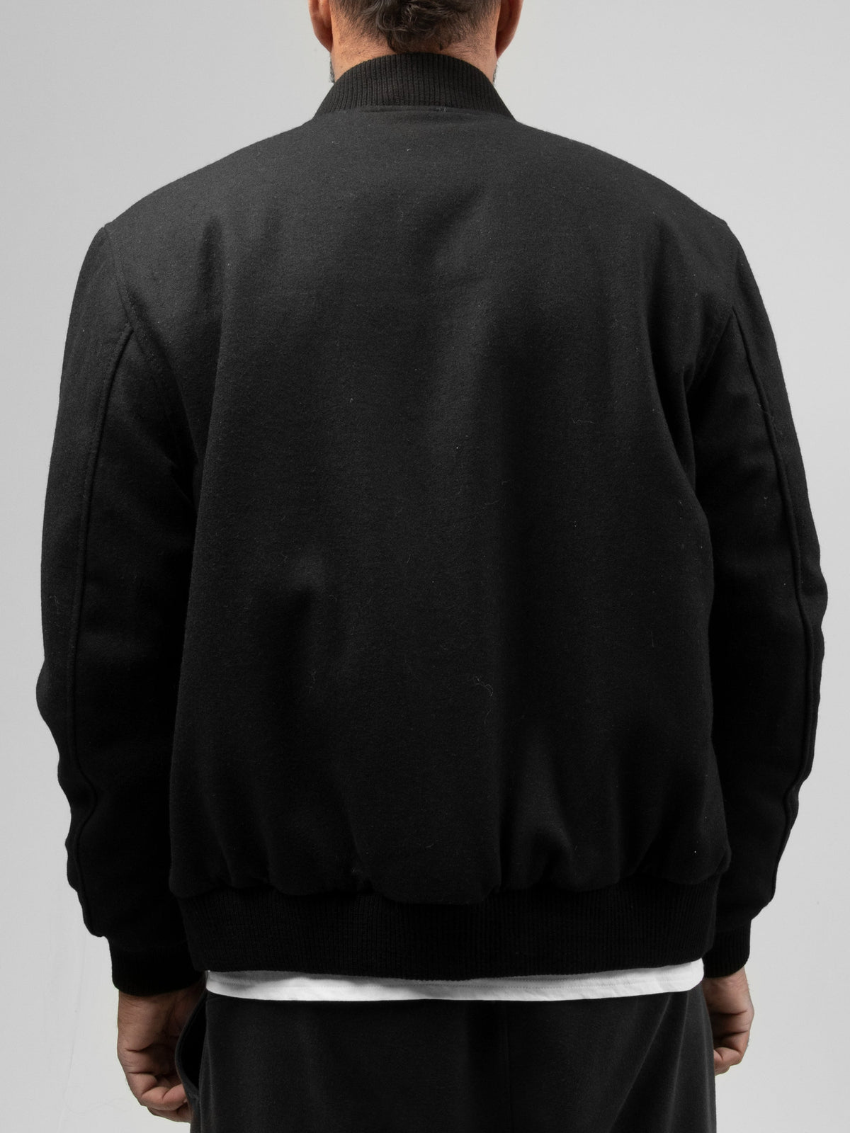 Back view of Whet Blu NYC Andre men's varsity leather jacket in black and white