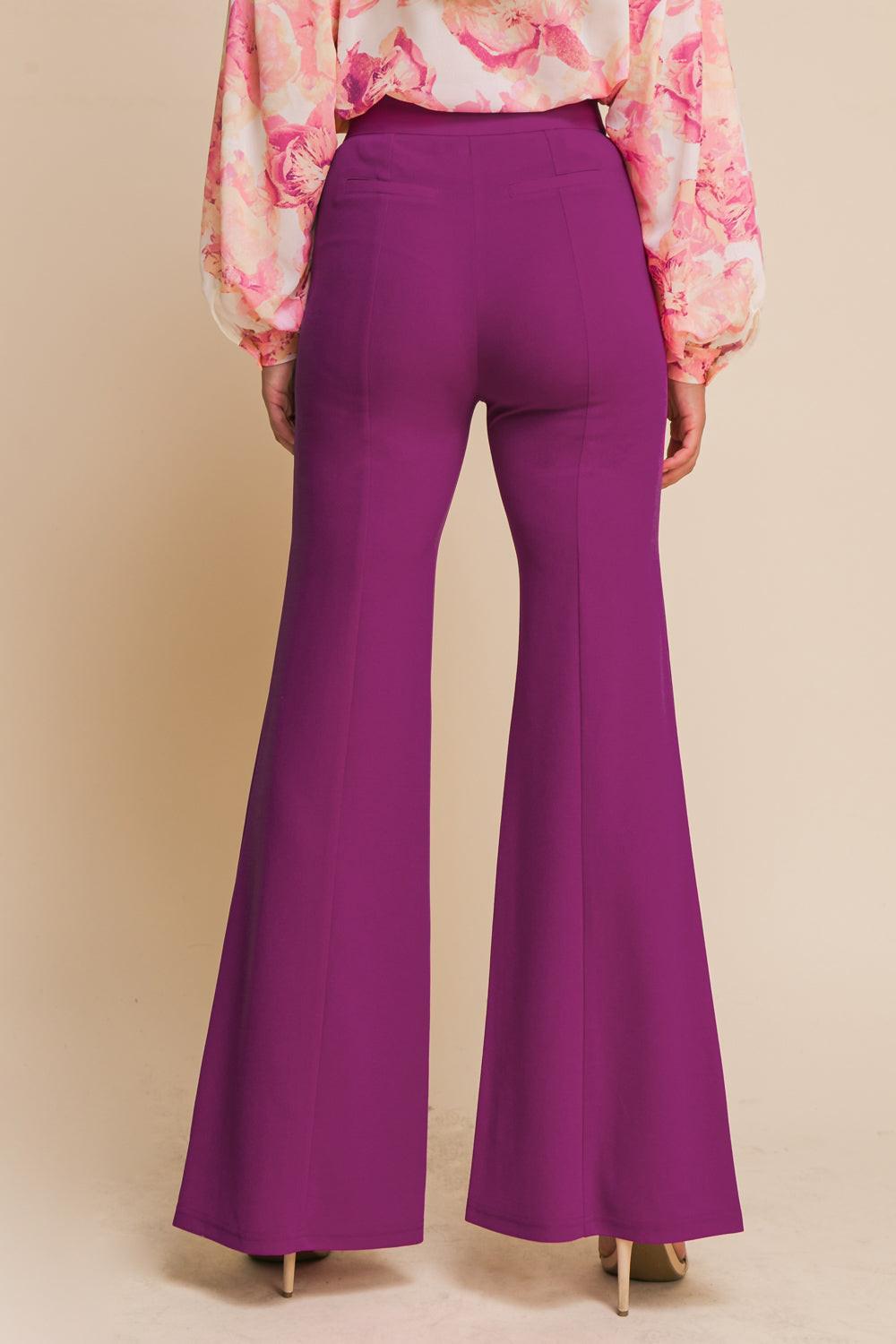 Flying Tomato Hey Darling woven flare pants with a high waist and vibrant pattern, displayed on a model against a white background.