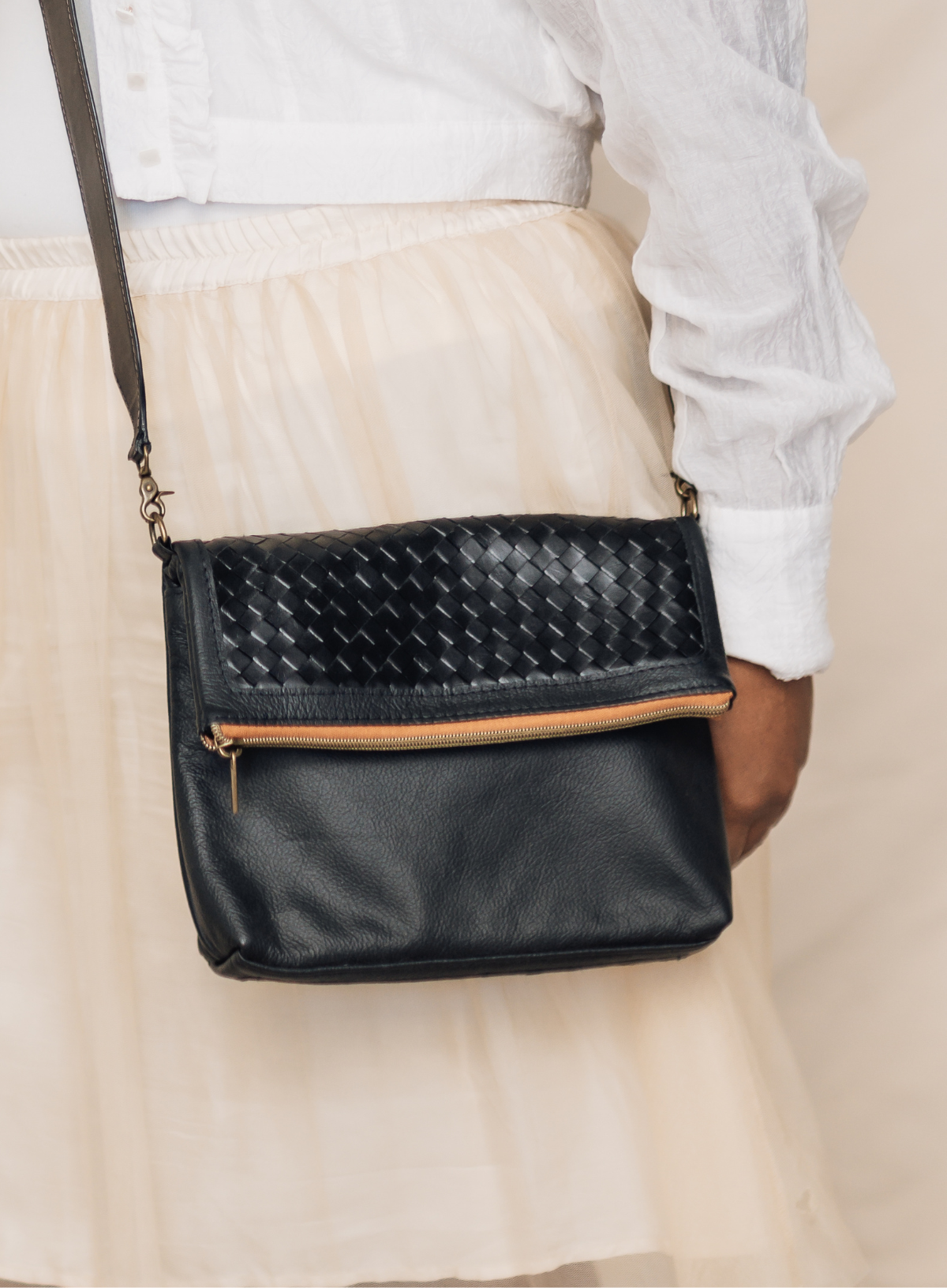 Deux Mains black woven Foldover Clutch Crossbody bag close-up with adjustable strap