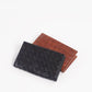Deux Mains woven card holder wallet in black and tan, front view